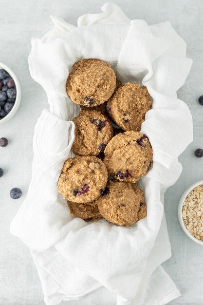 a bowl of blueberries and oatmeal muffins