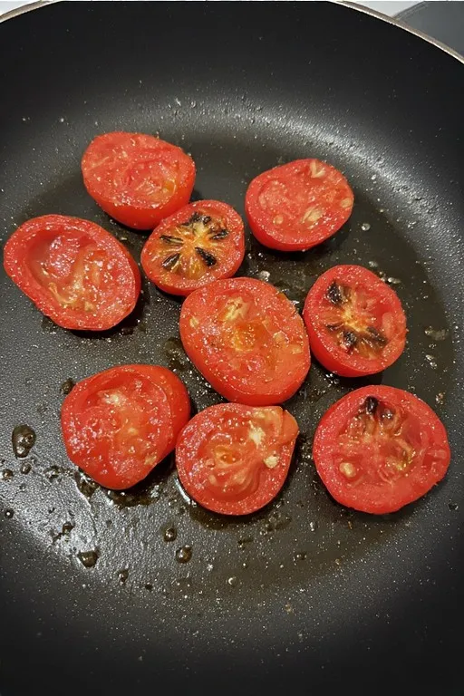 Cherry tomatoes blistering in garlic butter skillet for zucchini noodles recipe