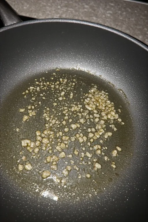Garlic sautéing in olive oil in skillet for garlic butter zucchini noodles