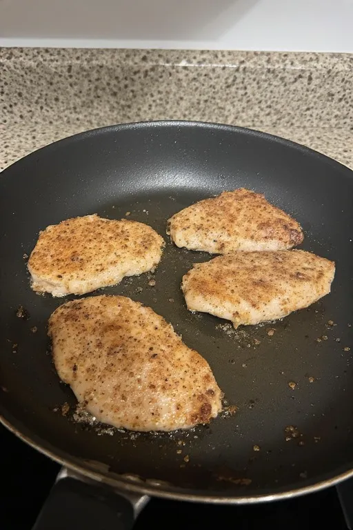 Chicken breast searing in skillet for healthy marry me chicken recipe