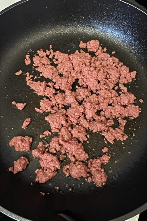 Ground beef browning in skillet for hot honey cottage cheese sweet potato beef bowl