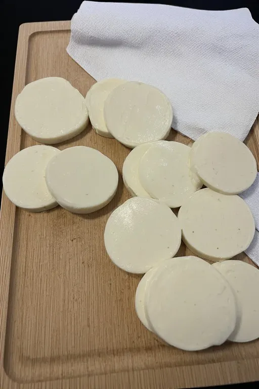 Fresh mozzarella sliced for cucumber caprese salad with balsamic