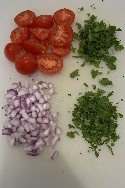 Chopped vegetables: tomatoes, onions, cilantro.