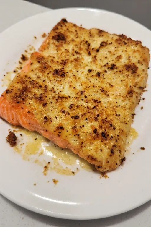 Baked Boursin salmon fillet served on plate with lemon