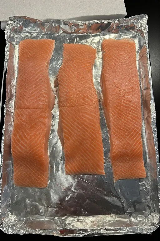 Raw salmon fillets on baking sheet for baked Boursin salmon recipe