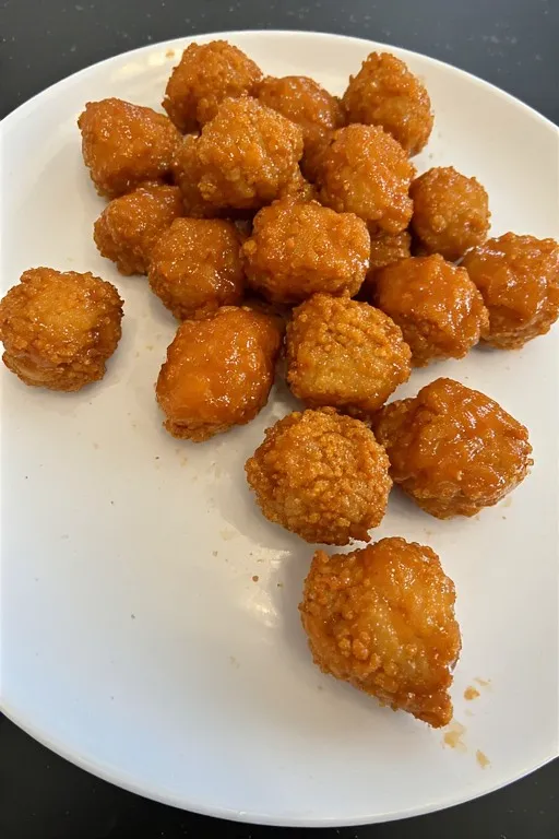 Bang bang salmon bites coated in sweet spicy sauce ready to serve