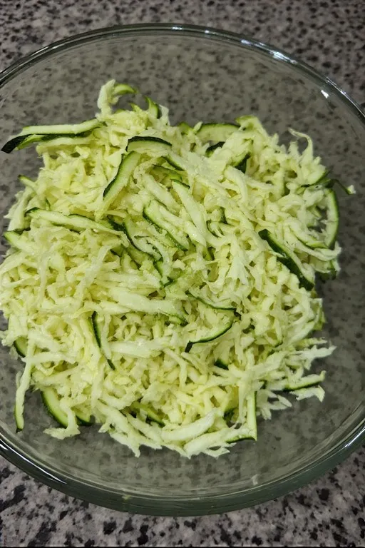 Shredded zucchini in a bowl for chocolate zucchini bread recipe
