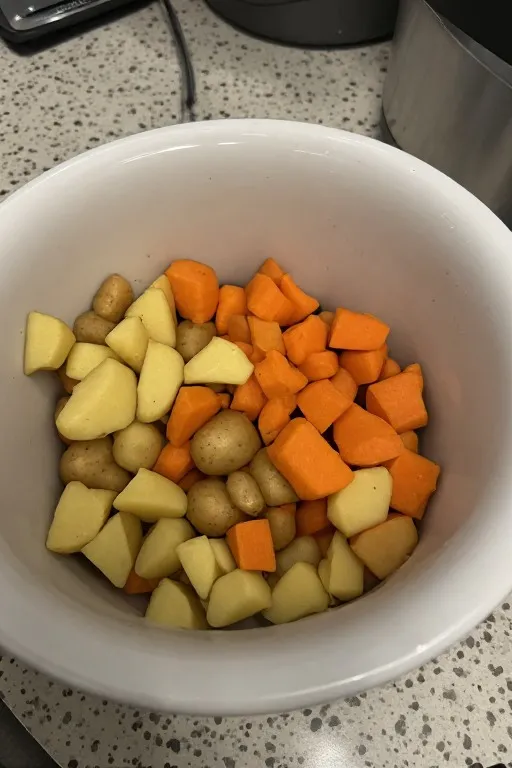 Vegetables arranged in bottom of crockpot before adding chicken thighs