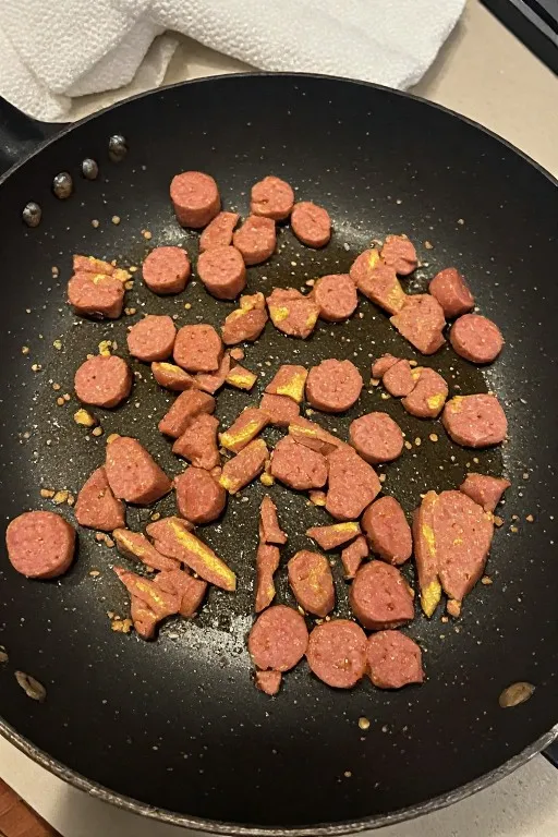 Breakfast sausage browning in skillet for freezer breakfast burritos recipe