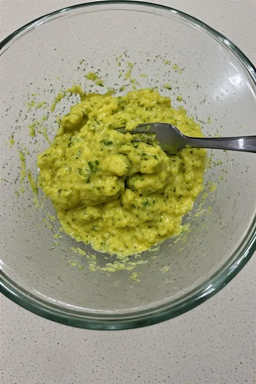 Keto zucchini fritter mixture with almond flour and parmesan in bowl