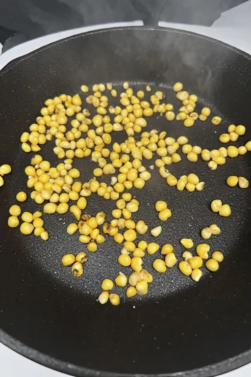 Corn charring in cast iron skillet for Mexican street corn dip recipe