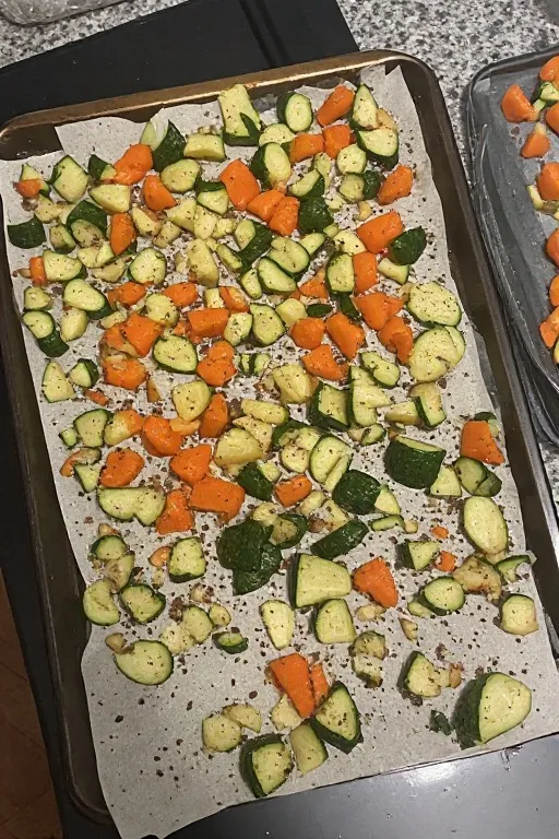 Seasoned vegetables spread in single layer on baking sheet with space between pieces
