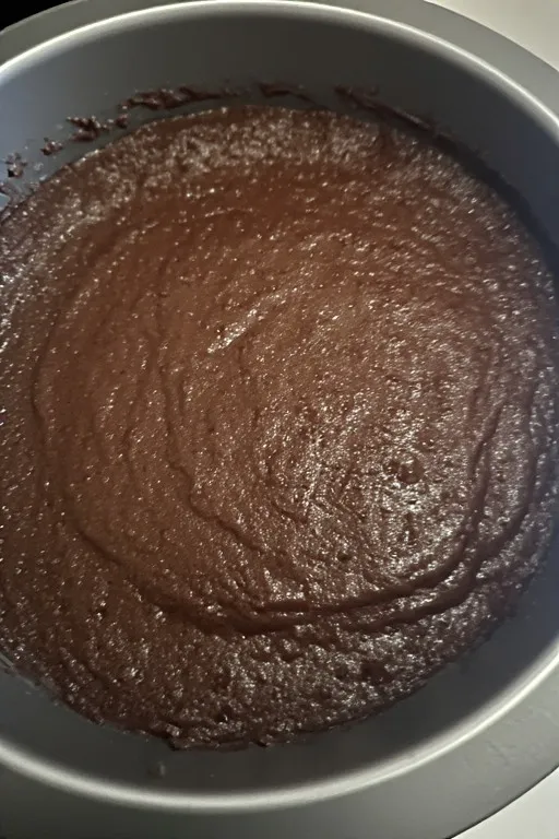 Zucchini brownie batter spread in baking pan before oven