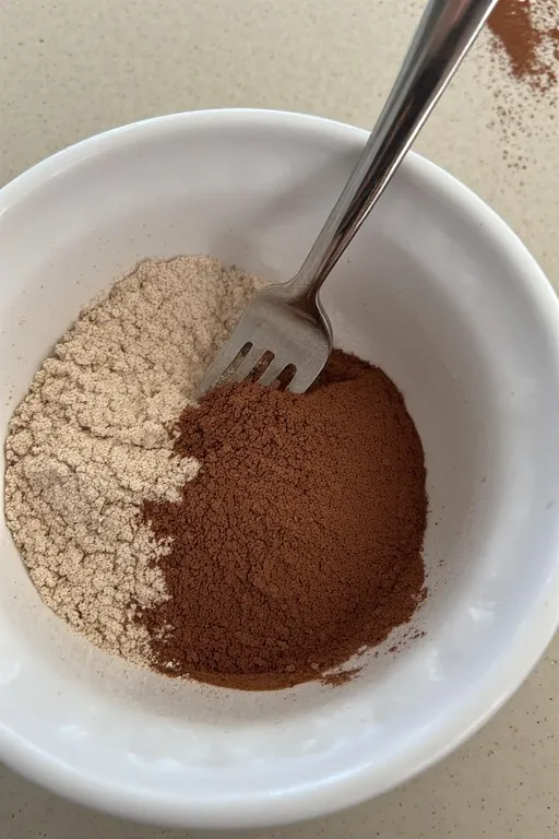 Cocoa powder and flour mixed for chocolate zucchini brownies