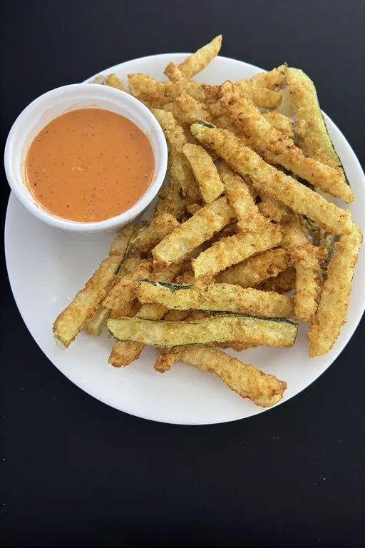 Keto zucchini fries recipe served on plate with spicy mayo dipping sauce