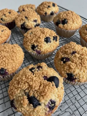 Best blueberry muffins with streusel topping cooling on wire rack