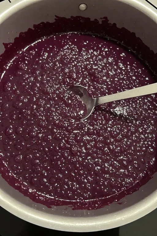 Homemade blackberry jam recipe bubbling in pot while cooking on the stove