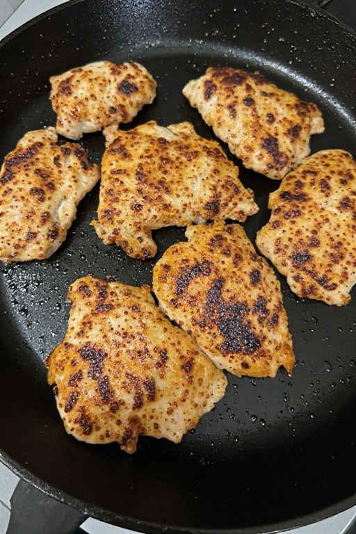 Fiesta lime chicken breasts cooking in cast iron skillet with golden sear