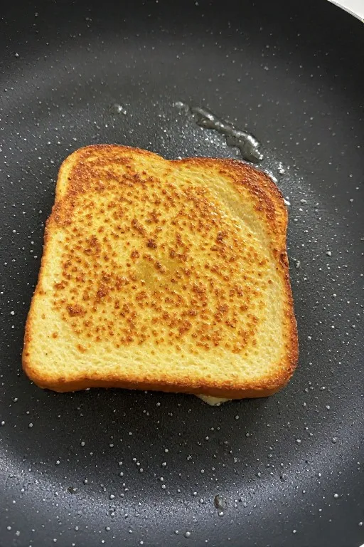 French toast cooking in pan with golden brown crust forming for best French toast recipe