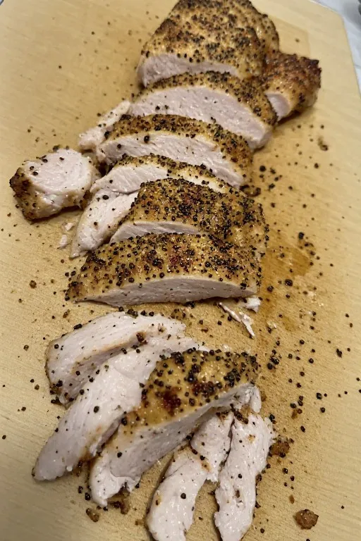 Sliced seasoned chicken breast for chicken rice bowls with creamy garlic sauce