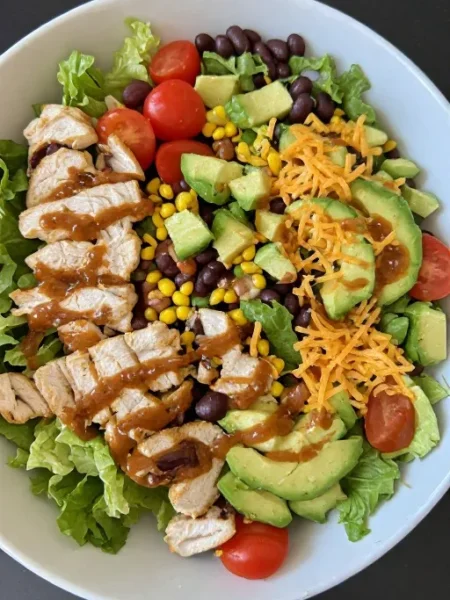 Southwest chicken salad with grilled chicken avocado black beans and chipotle lime dressing in bowl