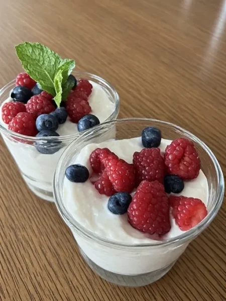 Two Greek yogurt parfaits in glasses served
