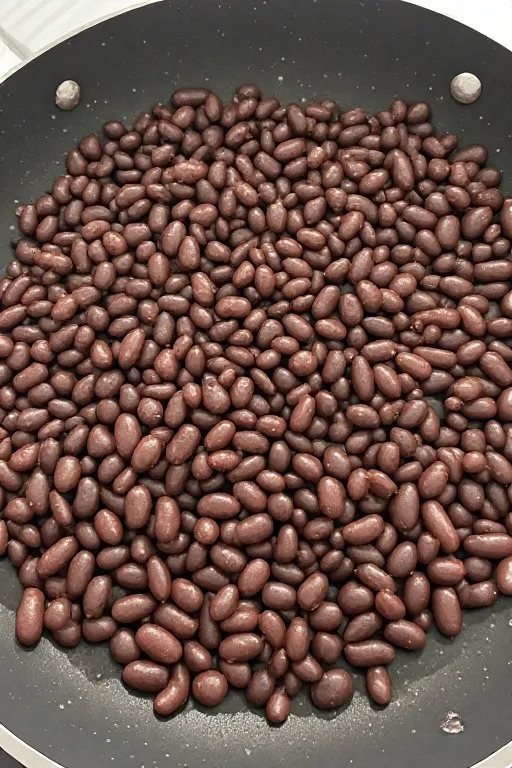 Seasoned black beans slightly mashed in skillet